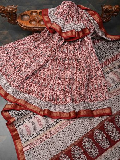 A lovely red and white block-printed cotton saree. The paisley motifs and intricate borders make it a beautiful example of traditional Indian textile art.