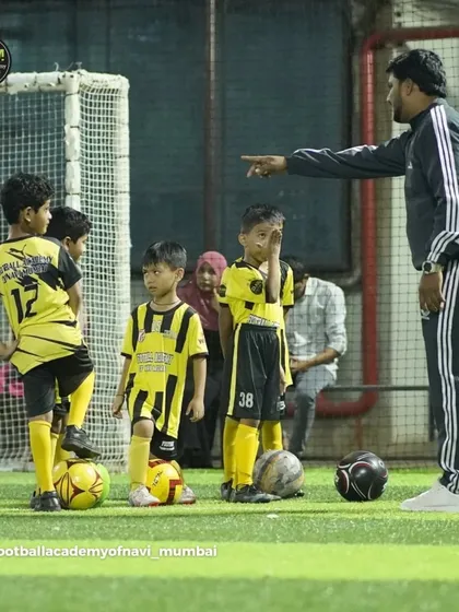 Clear instructions and demonstration are key. A coach points out the next step in a drill for our young players.