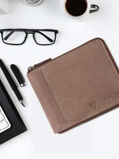 This is our super-soft genuine leather zip wallet, shown here in a professional workspace setting. Its compact and secure design is perfect for the modern business professional, offering both style and RFID protection.