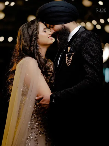 An intimate and romantic reception photo. The couple's close embrace and the soft lighting create a beautiful, timeless memory.