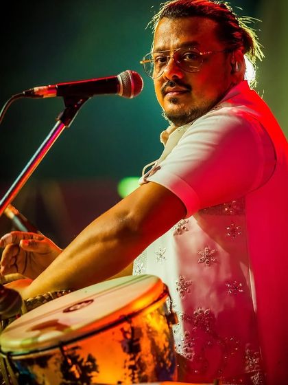 The heart of our rhythm section. Our percussionist smiling as he plays the tabla, enjoying the energy of the private show.