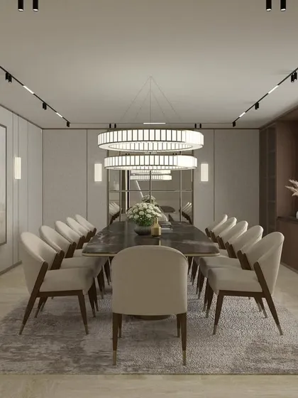 This formal dining room is designed for hosting in style. A long table is flanked by upholstered chairs under dramatic circular chandeliers, creating a space that is both impressive and intimate.