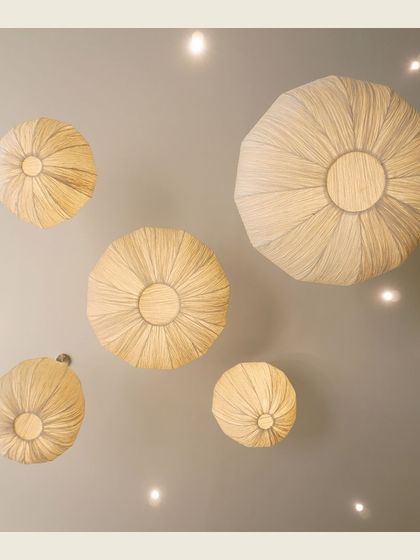 An overhead shot of our distinctive woven light fixtures, which have become a signature element of our interior design.
