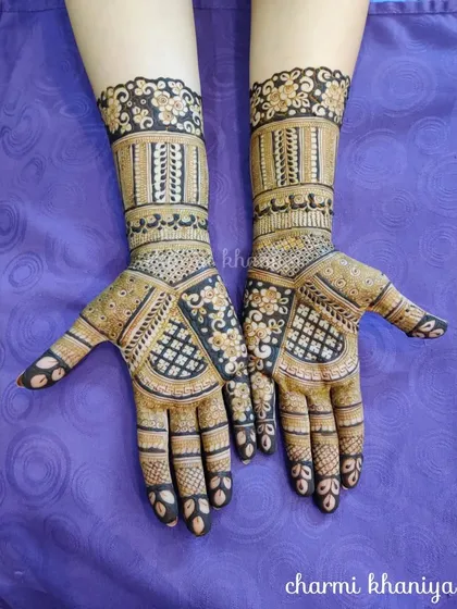 A beautiful example of a full coverage design with contrasting elements. The dark, filled-in floral patterns stand out against the delicate check-work on the palm.