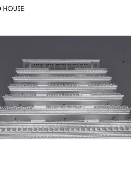 A low-angle, black and white photograph of the Soho House facade. This perspective emphasizes the building's repeating horizontal lines and classical details, celebrating the power of architecture to create inspiring and transformative spaces.