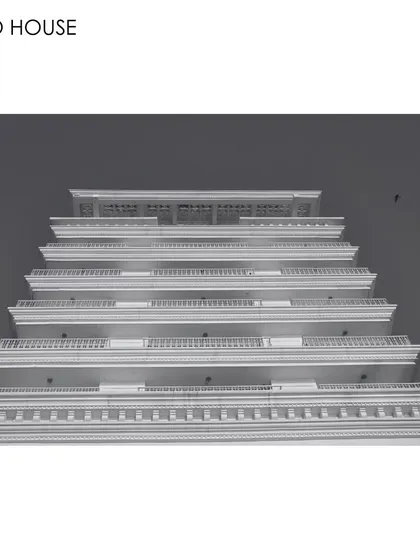 A low-angle, black and white photograph of the Soho House facade. This perspective emphasizes the building's repeating horizontal lines and classical details, celebrating the power of architecture to create inspiring and transformative spaces.
