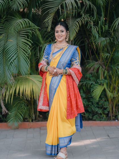 A full-length view of the stunning Paithani saree and the bride's graceful stance.