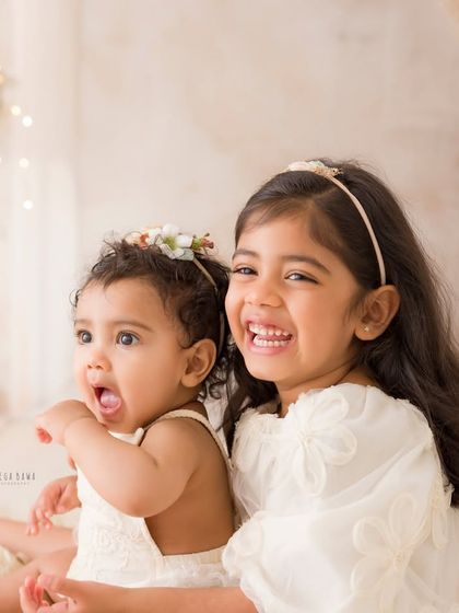 A moment of pure, unscripted joy between two sisters. Their spontaneous laughter makes this an authentic and heartwarming portrait.