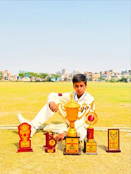 A young player with his trophies, a testament to his skill and the quality of training at our academy.