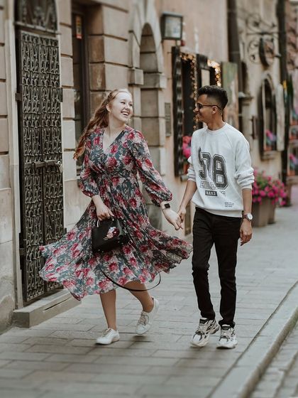 A candid moment of laughter and movement as Jaipal and Natalia stroll through the streets of Poland, their joy evident in every step.