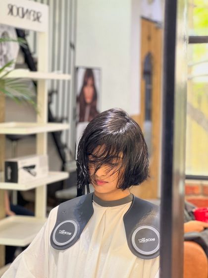 A behind-the-scenes look at the cutting process for a short, textured hairstyle. Precision is key to achieving the perfect shape.