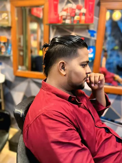 A side profile of the undercut with a top knot. This style offers the best of both worlds: long hair on top with the neatness of a short cut.
