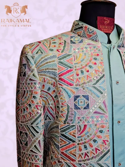 A close-up of the multi-colored geometric embroidery, showing the intricate threadwork and sequin details.