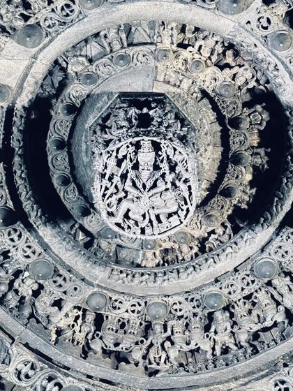 Looking up at the intricately carved ceiling of a Hoysala temple. I believe in mixing adventure with the rich culture of Karnataka.