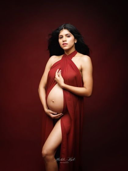 A powerful and confident pose using a draped red fabric, perfect for a Valentine's Day theme or any session celebrating love.