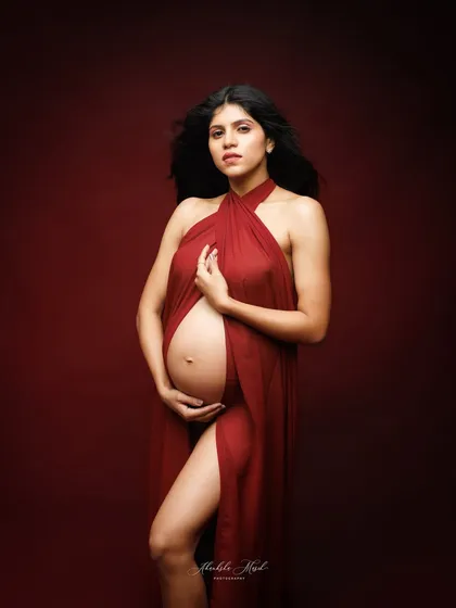 A powerful and confident pose using a draped red fabric, perfect for a Valentine's Day theme or any session celebrating love.