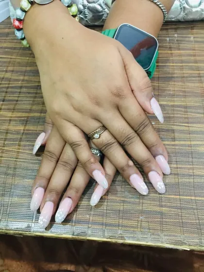 Showing off the elegant almond shape of these gel extensions. The subtle glitter catches the light beautifully, giving your hands a delicate and polished look.
