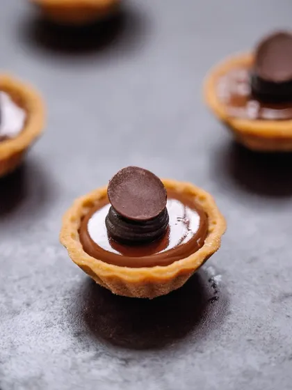 Another view of our double dark chocolate tartlets, showcasing their elegant simplicity. A perfect one-bite dessert for any occasion.