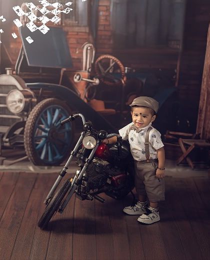 Ready for the open road. This little guy looks so proud standing next to his motorcycle in our vintage garage set.