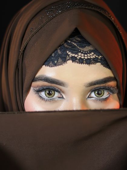 A stunning Hijabi makeup look, focusing on a dramatic full cut-crease eye makeup that stands out.