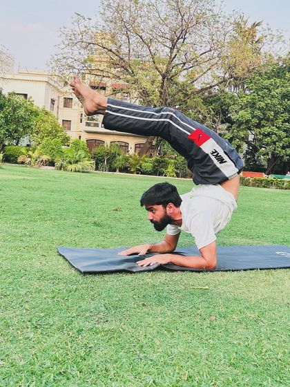 The forearm scorpion pose, another advanced inversion that requires significant shoulder strength and spinal flexibility.