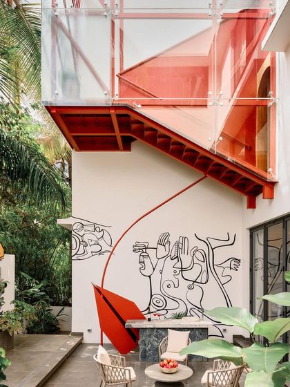 The 'Vyōmam' residence in Bangalore is a dialogue between tradition and contemporary expression, featuring a striking red sculptural element and a custom mural.