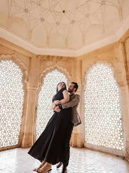 Inside the intricate marble halls of Amer Fort, we captured this moment of pure joy. The way the light filters through the jali windows creates a timeless, fine-art feel, perfect for a couple wanting elegant and romantic portraits.
