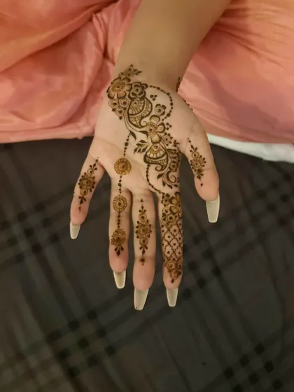 A stylish and modern design featuring peacock and jhumka (earring) motifs that trail down the fingers.