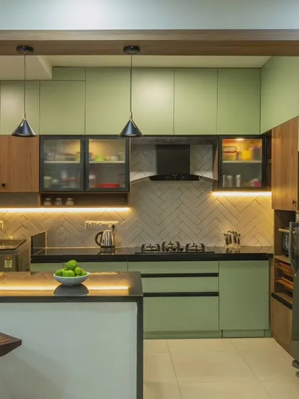 This open-plan kitchen features a mint green and wood palette with a herringbone tile backsplash. I designed it with a breakfast counter and smart lighting to create a space that is both highly functional and visually connected to the living area.