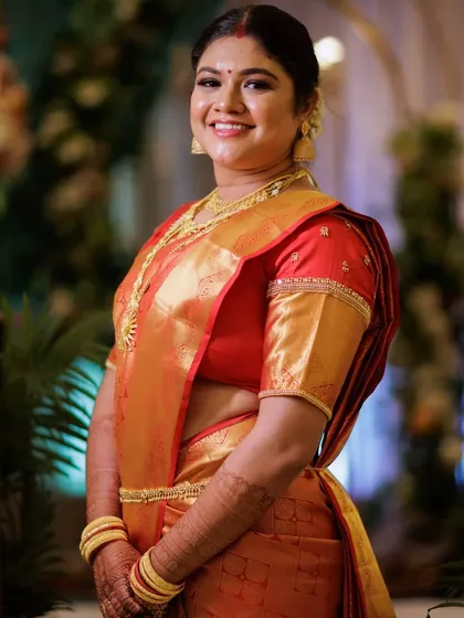 The bride's full reception look, including expert saree draping that complements her figure. The makeup is designed to last all evening, keeping her looking fresh and radiant.