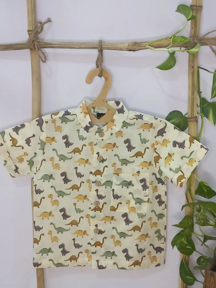 Time to get ready for some roaring fun! This dinosaur print shirt is a favorite among little guys. Made from soft cotton, it's perfect for school, playdates, or just a day of imaginative play.