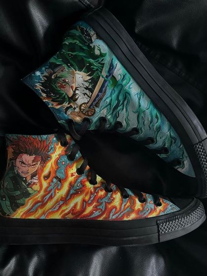 Both shoes of the custom Tanjiro Converse pair, displaying the fire and water breathing techniques.