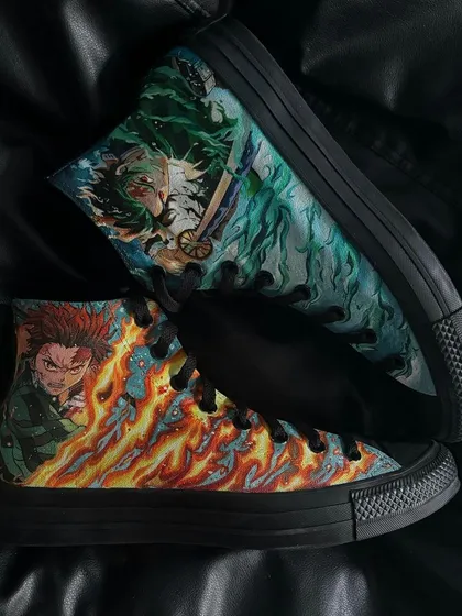 Both shoes of the custom Tanjiro Converse pair, displaying the fire and water breathing techniques.