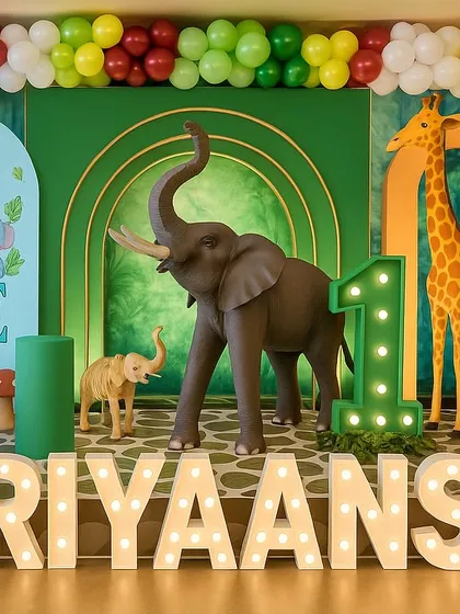 A clearer daytime view of the "Wild One" setup for Hariyaansh. You can see the vibrant colors of the balloon arch and the friendly cartoon animals on the welcome board, perfect for a first birthday.