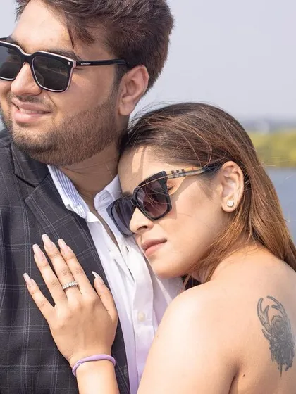 An intimate and tender moment, with the bride resting her head on the groom's chest during their yacht photoshoot in Goa.