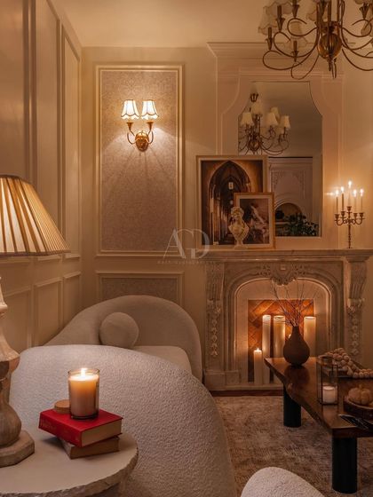 Another view of the candlelit lounge, emphasizing the soft curves of the chaise lounge against the formal lines of the wall paneling. This contrast creates a space that is both sophisticated and comfortable.
