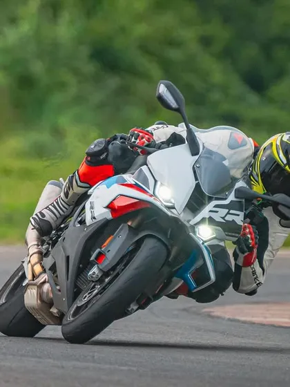 A rider perfectly positioned on a BMW S1000RR, demonstrating the kind of control and technique we teach. Mastering your machine on a race track is one of the best feelings in the world.