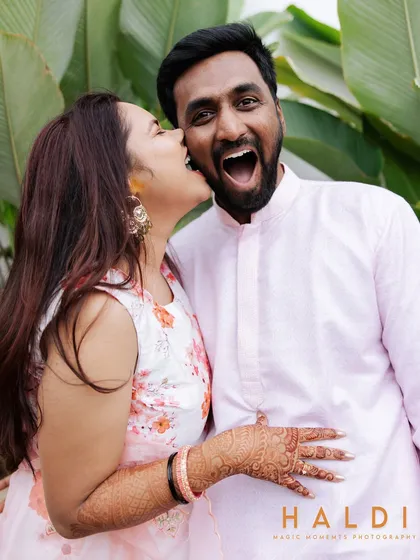 A playful and candid moment from the Haldi ceremony. The bride's joyful expression as she teases the groom is what makes this photo special.