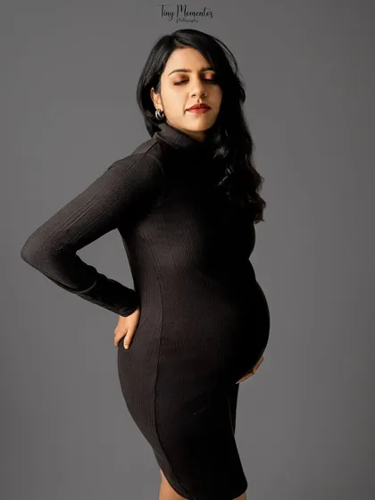 A serene and introspective portrait. With eyes closed, this image captures a quiet moment of connection between mother and baby.
