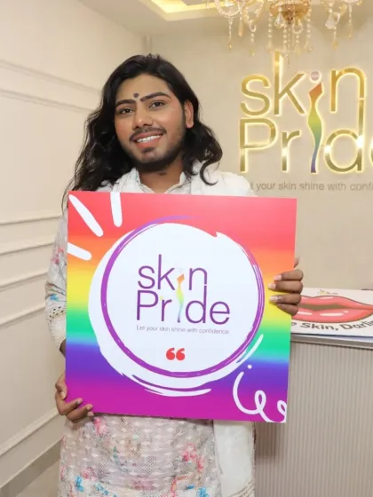 The smiles of our clients say it all. Here is a happy client at our grand opening event, holding our pride board. We are here to help you let your skin shine with confidence.