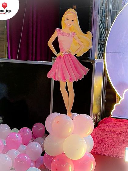 Come on Barbie, let's go party! A life-sized Barbie cutout stands on a cloud of pink and white balloons, adding the perfect thematic touch to this glamorous and fun-filled birthday celebration.