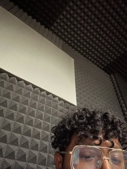 A candid shot of me in the recording booth. This is my sanctuary, the place where I turn thoughts and stories into powerful rap verses.
