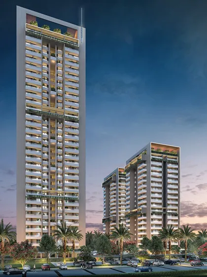 A render of a new high-rise residential tower in development, featuring a sleek, modern design with extensive use of glass and green balconies.