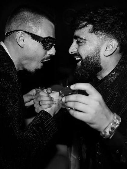 Two friends sharing a laugh and a drink at the sangeet. I capture the fun moments between guests that add to the story of the day.
