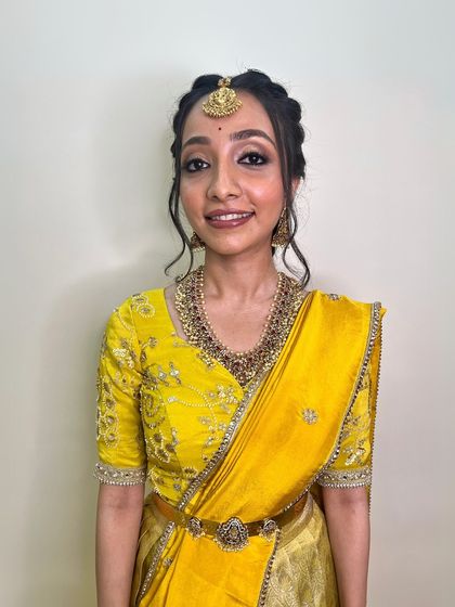 A simple and elegant South Indian look. The makeup is minimal and clean, enhancing her natural features for a timeless and graceful appearance.