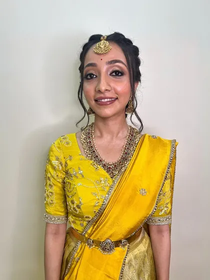 A simple and elegant South Indian look. The makeup is minimal and clean, enhancing her natural features for a timeless and graceful appearance.