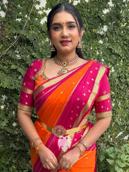 My client Kshipra looks absolutely radiant in this hot pink and orange silk blouse. I designed this piece with a structured fit and intricate gold zari detailing along the neckline and sleeves to create a timeless statement of heritage and personal style.