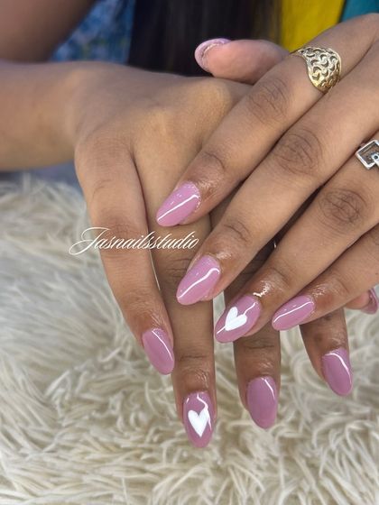 A pretty mauve manicure with simple white heart accents. This is a sweet and romantic design.