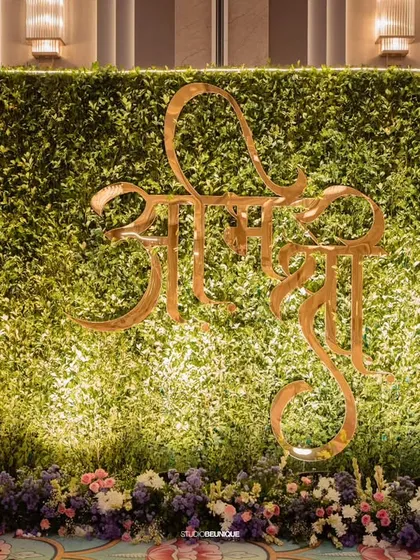 A closer look at the "Shree" green wall, a unique and personalized element for the couple's celebration.