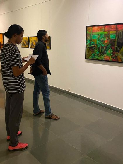 Visitors viewing one of the large-scale, vibrantly lit photographs from Sandeep TK's exhibition.